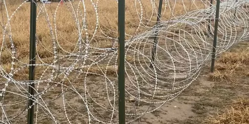 Ground-based razor wire installation